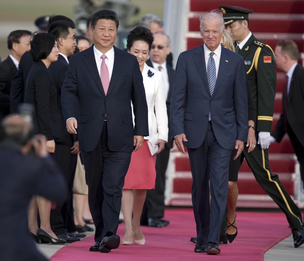 FILE - Chinese President Xi Jinping and Vice President Joe Biden walk down the red carpet on the tarmac during an arrival ceremony in Andrews Air Force Base, Md., Sept. 24, 2015. As President Joe Biden and Xi Jinping prepare to hold their first summit on Monday, Nov. 15, the increasingly fractured U.S.-China relationship has demonstrated that the ability to connect on a personal level has its limits. Biden nonetheless believes there is value in a face-to-face meeting, even a virtual one like the two leaders will hold Monday evening. (AP Photo/Carolyn Kaster, File)