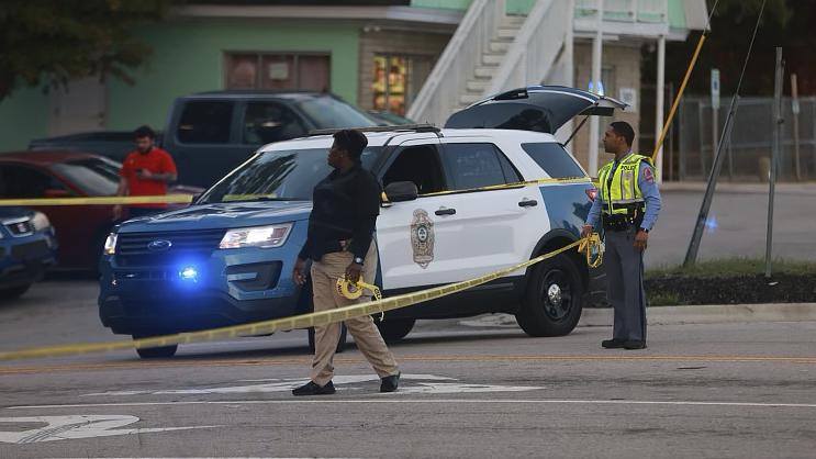 Law enforcement officers block off Old Milburnie Road during a shooting in Raleigh, N.C., Thursday, Oct. 13, 2022. (Robert Willett/The News & Observer via AP)
