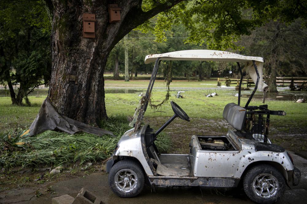 A muddy golf cart sits in a driveway of Gary and Joy Rhodes following heavy rainfall on Saturday, Aug. 21, 2021, in Dickson, Tenn. (Josie Norris/The Tennessean via AP)