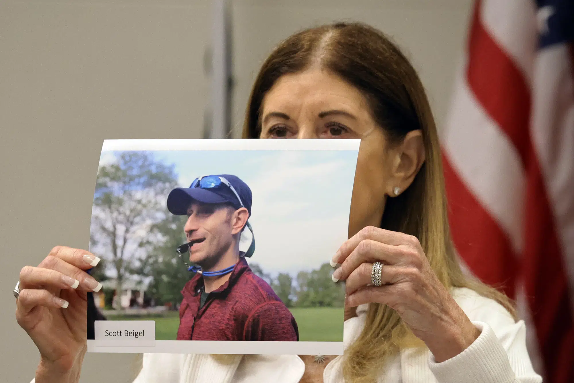 FILE - Linda Beigel Schulman holds a photograph of her son, Scott Beigel, before giving her victim impact statement during the penalty phase of Marjory Stoneman Douglas High School shooter Nikolas Cruz's trial at the Broward County Courthouse in Fort Lauderdale, Fla., Monday, Aug. 1, 2022. Scott Beigel was killed in the 2018 shootings. (Amy Beth Bennett/South Florida Sun Sentinel via AP, Pool, File)