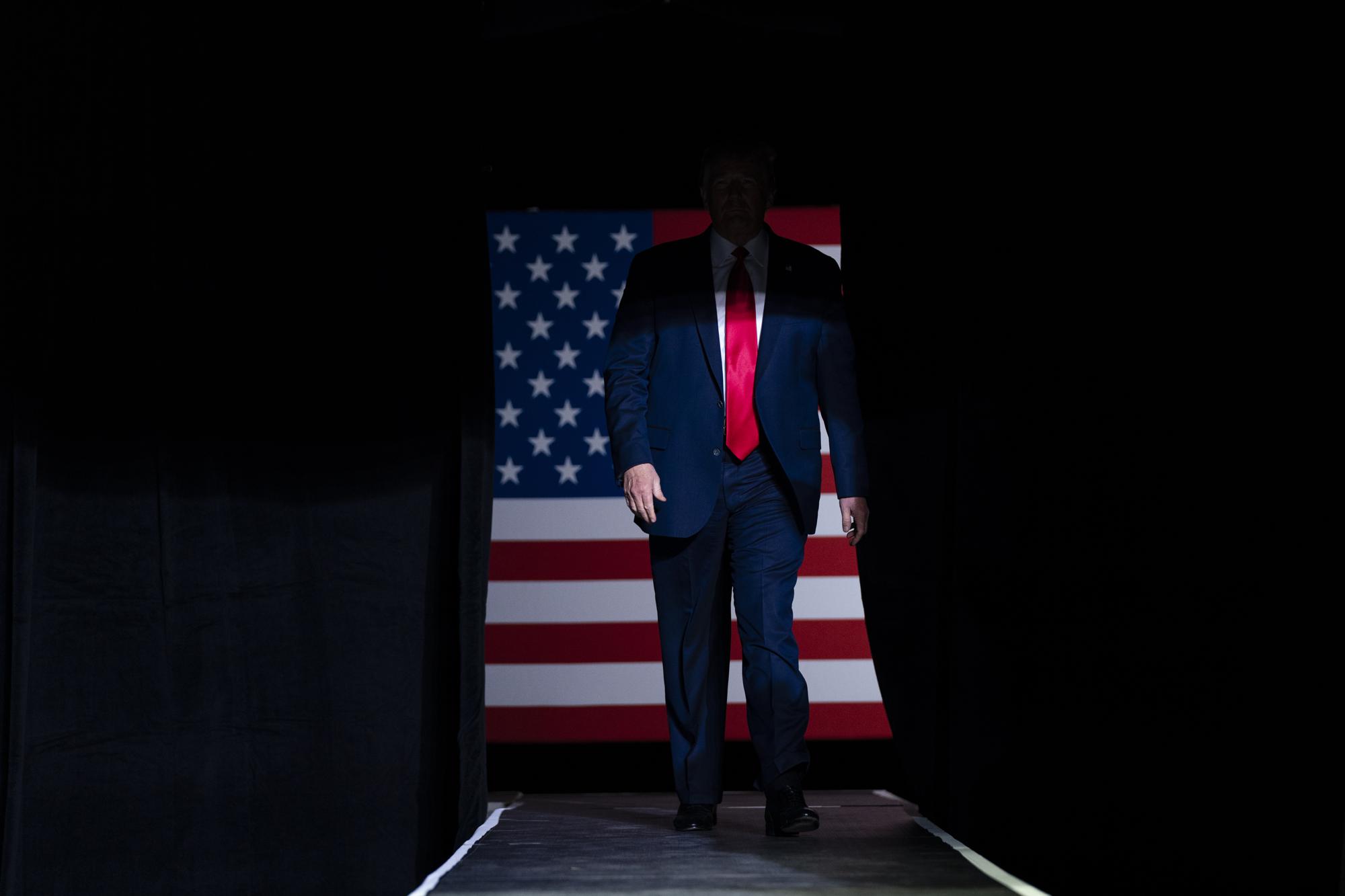 FILE - In this June 20, 2020, file photo, President Donald Trump arrives on stage to speak at a campaign rally at the BOK Center, in Tulsa, Okla. Reports of hateful and violent speech on Facebook poured in on the night of May 28 after President Donald Trump hit send on a social media post warning that looters who joined protests following Floyd's death last year would be shot, according to internal Facebook documents shared with The Associated Press. (AP Photo/Evan Vucci, File)