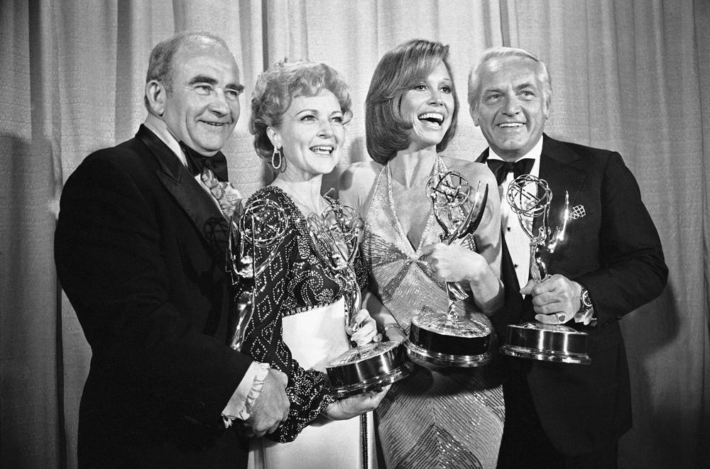 FILE - In this May 18, 1976 file photo, cast members of the "Mary Tyler Moore Show," pose with their Emmys backstage, at the 28th annual Emmy Awards in Los Angeles. From left are, Ed Asner, Betty White, Mary Tyler Moore and Ted Knight.  Betty White, whose saucy, up-for-anything charm made her a television mainstay for more than 60 years, has died. She was 99.   (AP Photo/Reed Saxon, file)