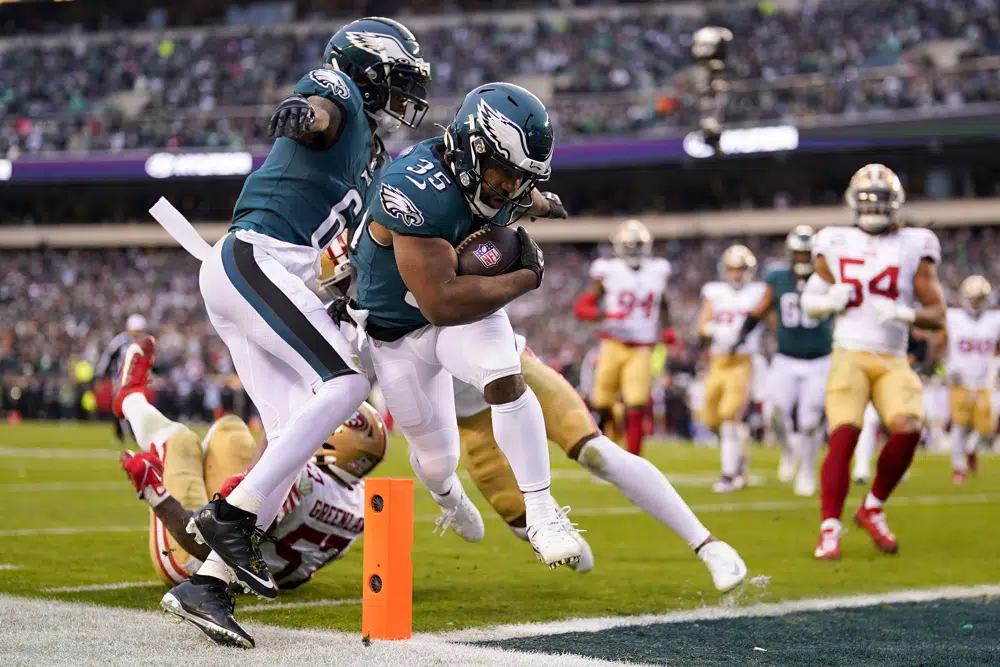 Philadelphia Eagles running back Boston Scott, center, runs for a touchdown during the first half of the NFC Championship NFL football game between the Philadelphia Eagles and the San Francisco 49ers on Sunday, Jan. 29, 2023, in Philadelphia. (AP Photo/Matt Slocum)