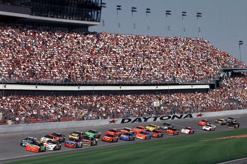 FILE - In this Feb. 11, 1999, file photo, drivers in the first 125-mile Daytona 500 qualifying race start the race at Daytona International Speedway in Daytona Beach, Fla. Daytona Beach became the unofficial "Birthplace of Speed" in 1903 when two men argued over who had the fastest horseless carriage and decided things in a race on the white, hard packed sand along the Atlantic Ocean.(AP Photo/Chris O'Meara, File)