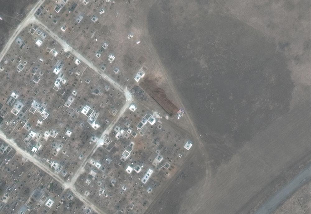 This satellite image provided by Maxar Technologies shows a closer view of new graves being dug at a cemetery near Vynohradne, approximately 12 kilometers east of Mariupol, Ukraine, on March 29, 2022. From mid-March through mid-April, there are new excavations at Vynohradne that consist of parallel trenches, with each trench approximately 40-meters long. (Satellite image ©2022 Maxar Technologies via AP)