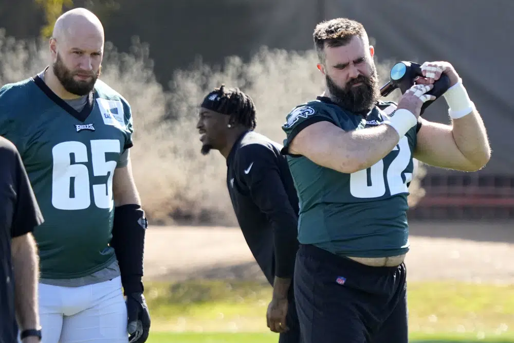 Philadelphia Eagles center Jason Kelce (62) and offensive tackle Lane Johnson (65) warm up during an NFL football Super Bowl team practice, Wednesday, Feb. 8, 2023, in Tempe, Ariz. The Eagles will face the Kansas City Chiefs in Super Bowl 57 Sunday. (AP Photo/Matt York)