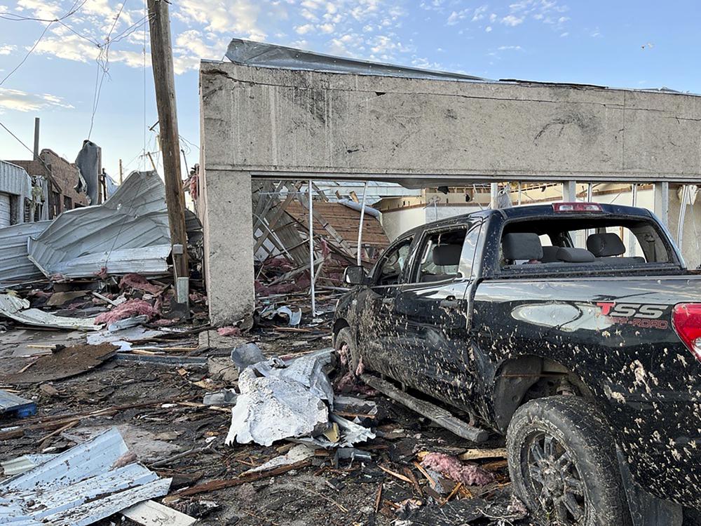 Buildings and a vehicle bear damage from a tornado in Perryton, Texas, Thursday, June 15, 2023. (Alex Driggars/Lubbock Avalanche-Journal via AP)