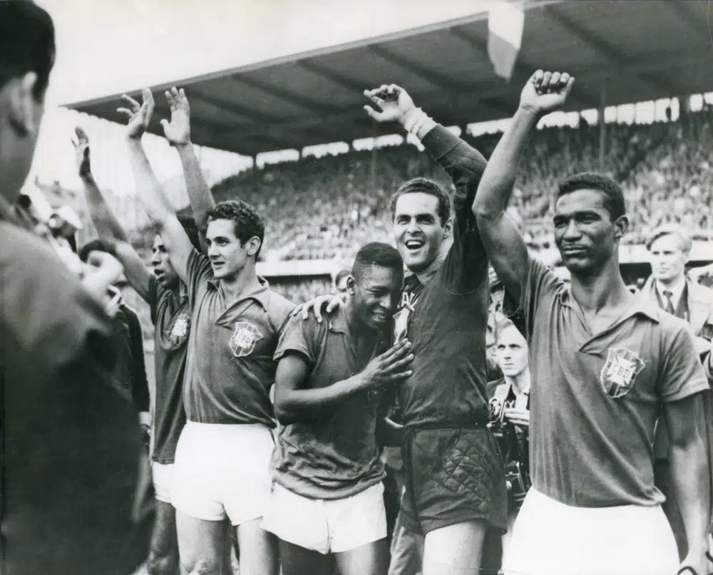 FILE - Brazil's 17-year-old Pele weeps on the shoulder of goalkeeper Gylmar Dos Santos Neves after Brazil's 5-2 victory over Sweden in the final of the soccer World Cup in Stockholm, Sweden, June 29, 1958. Pelé, the Brazilian king of soccer who won a record three World Cups and became one of the most commanding sports figures of the last century, died in Sao Paulo on Thursday, Dec. 29, 2022. He was 82. (AP Photo File)