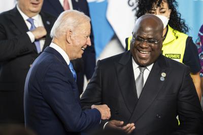 U.S. President Joe Biden shares a light moment with the President of the Democratic Republic of the Congo Felix Tshisekedi during the family photo of the G20 summit at the La Nuvola conference center, in Rome, Saturday, Oct. 30, 2021. The two-day Group of 20 summit is the first in-person gathering of leaders of the world's biggest economies since the COVID-19 pandemic started.  (Erin Schaff/Pool Photo via AP)