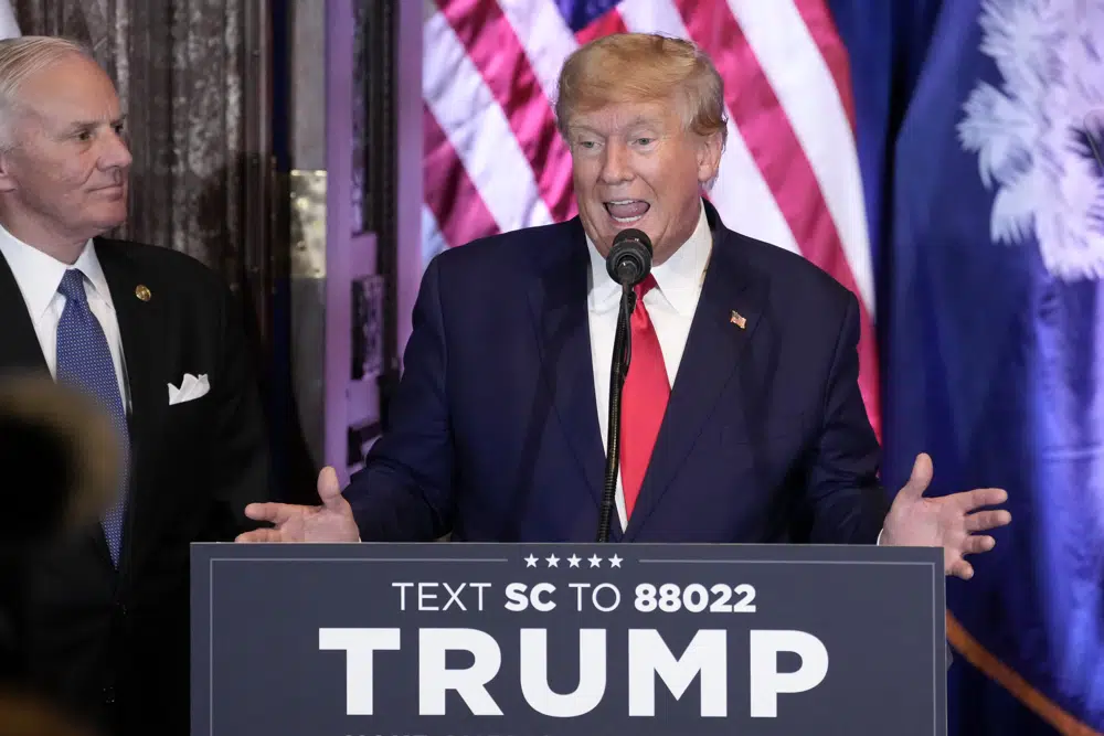 Former President Donald Trump speaks at a campaign event at the South Carolina Statehouse, Saturday, Jan. 28, 2023, in Columbia, S.C. South Carolina Gov. Henry McMaster, listens at left. (AP Photo/Alex Brandon)