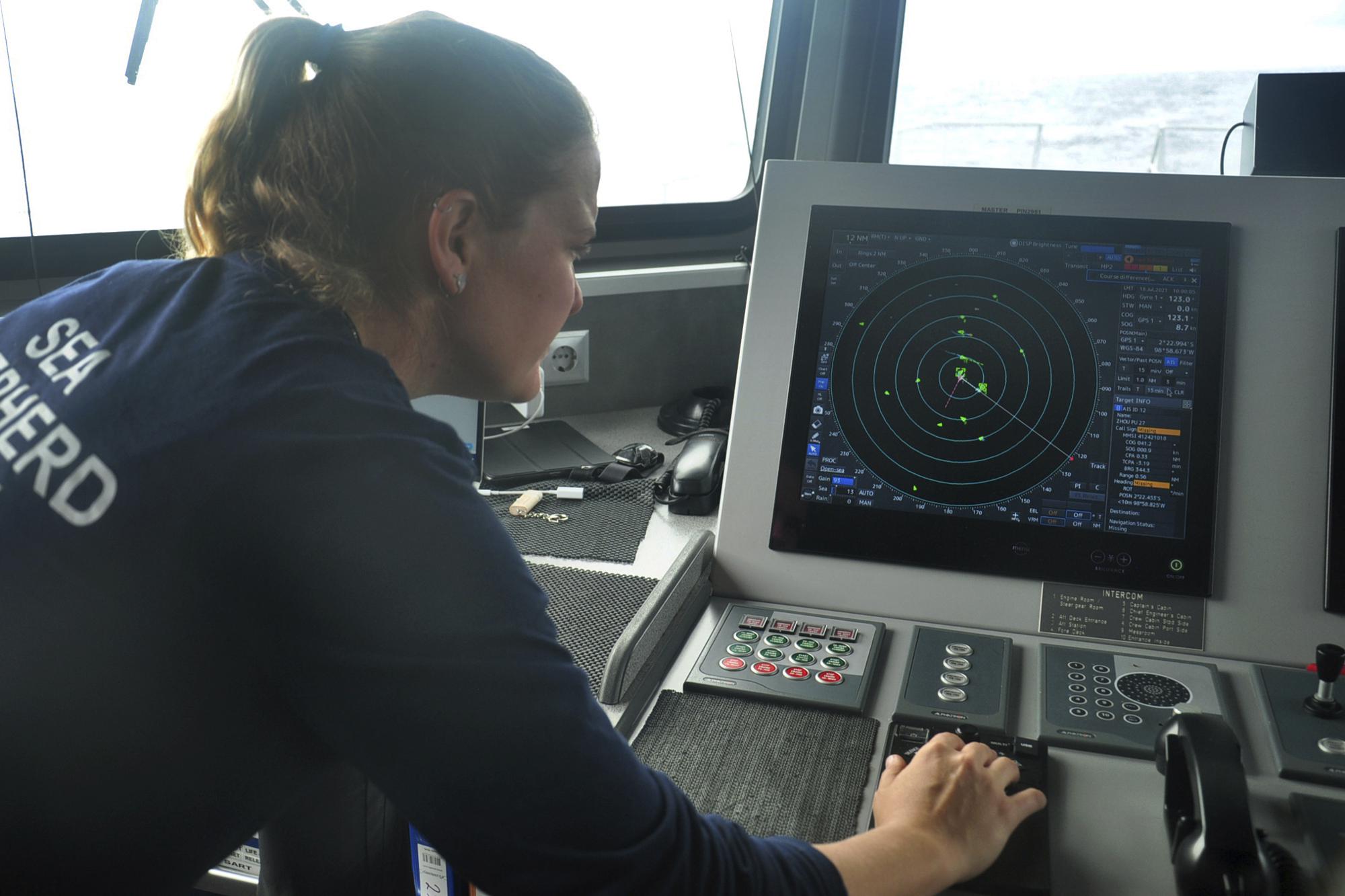 Carmen McGregor, second officer of the Ocean Warrior, checks the radar system on July 18, 2021, as part of the ship’s 18-day voyage to observe up close the activities of the Chinese distant water fishing fleet off the west coast of South America. (AP Photo/Joshua Goodman)
