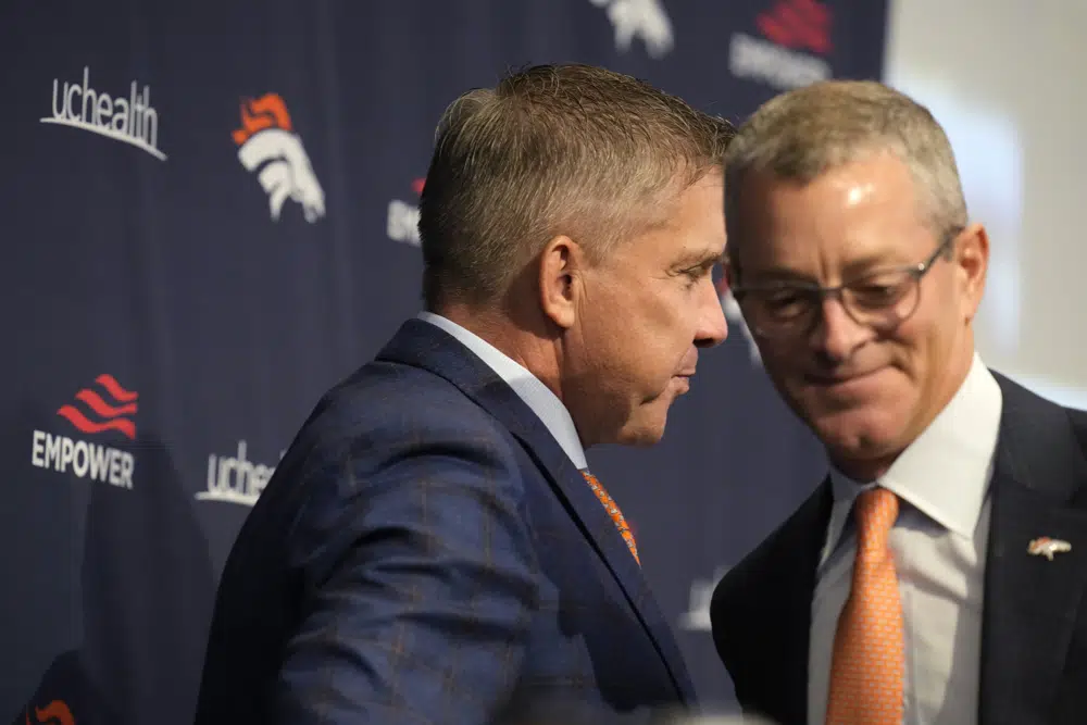 Denver Broncos new head coach Sean Payton, front, is introduced by the team's chief executive officer Greg Penner, during a news conference at the team's headquarters on Monday, Feb. 6, 2023, in Centennial, Colo. (AP Photo/David Zalubowski)
