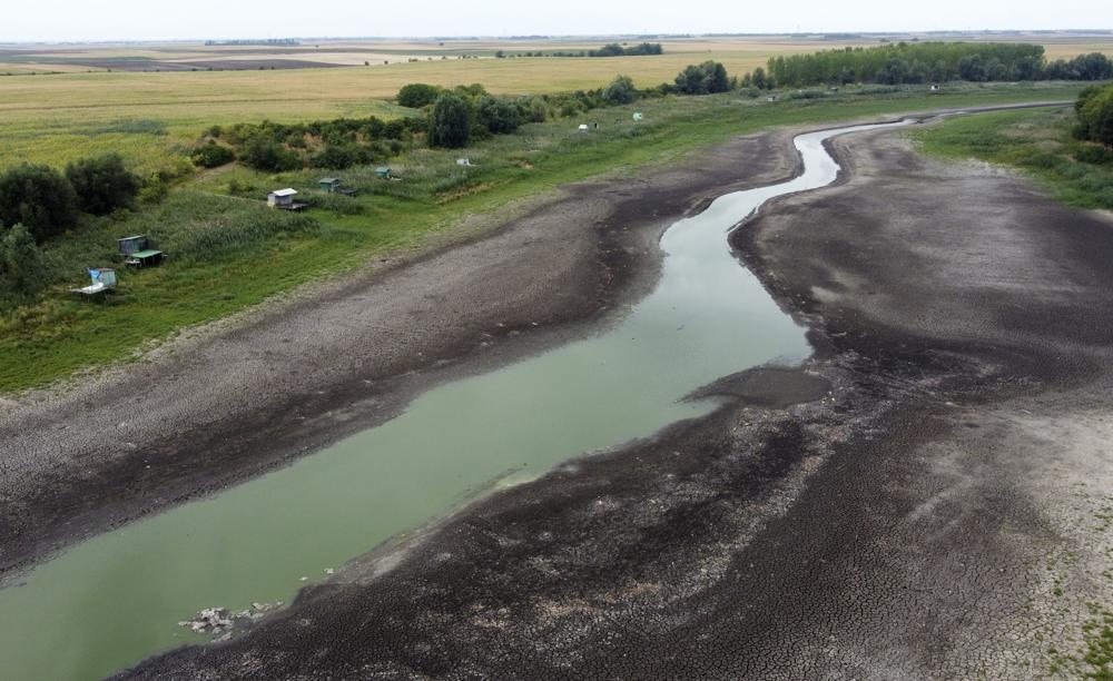 FILE - A view of a dry lake bed near the village of Conoplja, 150 kilometers north-west of Belgrade, Serbia, Tuesday, Aug. 9, 2022. Water shortages reduced Serbia's hydropower production. (AP Photo/Darko Vojinovic, File)