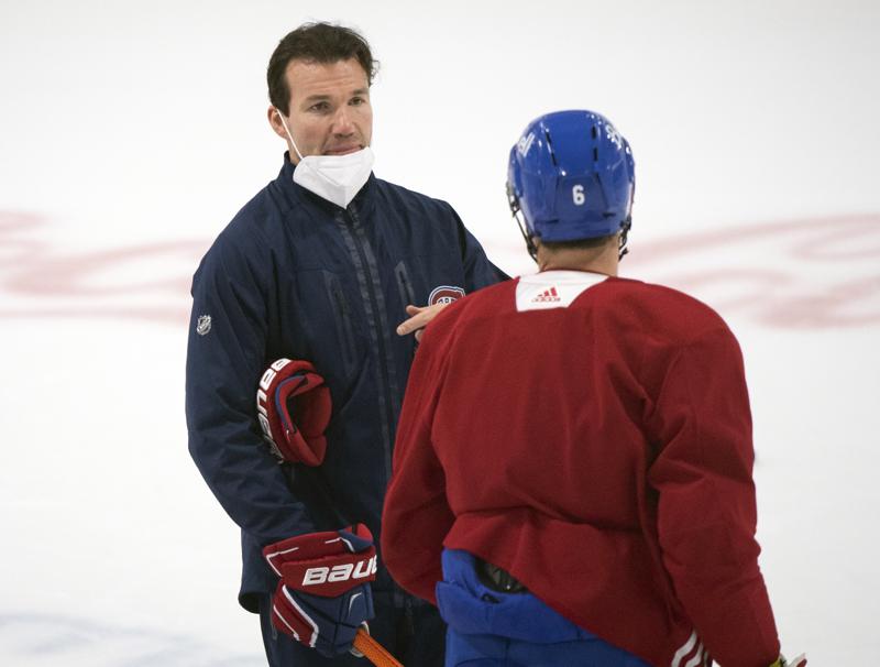 FILE- Montreal Canadiens interim head coach Luke Richardson, left, talks with captain Shea Weber during NHL hockey practice in Brossard, Quebec, on June 27, 2021. The Canadiens take on the Tampa Bay Lightning in the NHL hockey Stanley Cup finals beginning Monday in Tampa, Fla. The Chicago Blackhawks are nearing a deal with Richardson to become their next coach, according to a person familiar with the talks who spoke to The Associated Press on Friday, June 24, 2022, on condition of anonymity because the deal had not been completed. (Graham Hughes/The Canadian Press via AP)