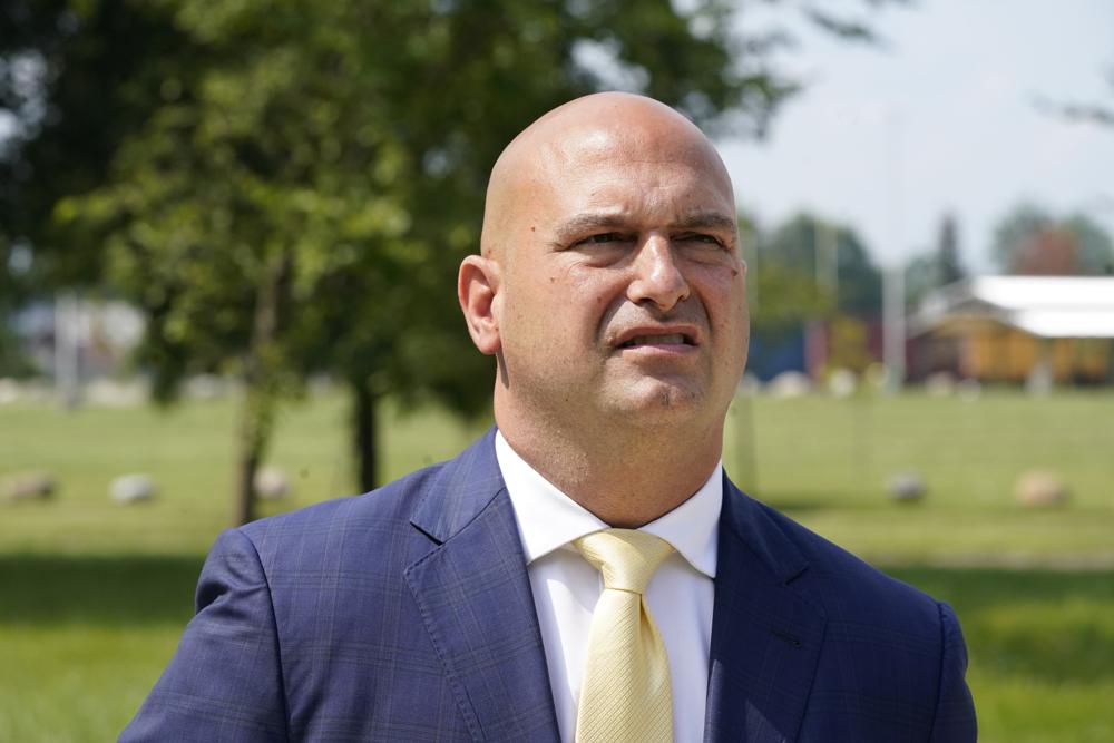 Dr. Nikolai Vitti, superintendent of Detroit Public Schools Community District, speaks during an interview outside Cody High School in Detroit on Friday, Aug. 20, 2021. In the wake of new federal pandemic funding, the district plans to add mental health services in dozens of schools, but it’s being done through a contractor. Even the building improvements will only be temporary if the district does not get additional funding to maintain them, he says. (AP Photo/Carlos Osorio)