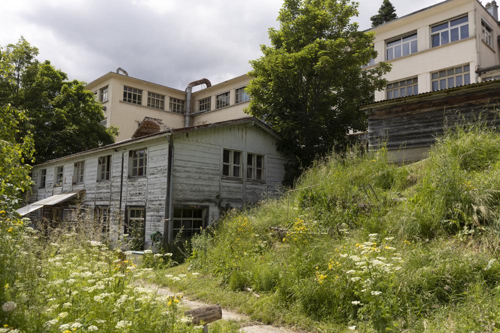 This Wednesday, June 23, 2021 photo shows an abandoned music box factory in Sainte-Croix, Switzerland, where Lola Montemaggi stayed after the April abduction of her 8-year-old daughter in France. A group of men inspired by QAnon-style conspiracy theories are accused of kidnapping the girl to return her to Montemaggi, who had lost custody. (AP Photo/Jean-Francois Badias)