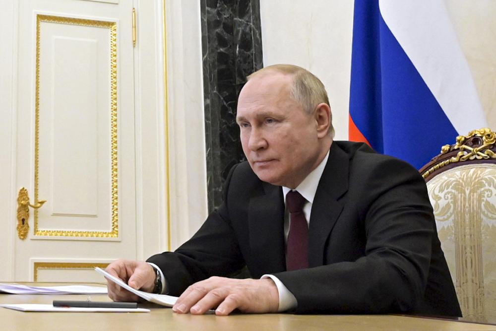 Russian President Vladimir Putin talks via videoconference with members of the Russian Paralympic Committee team on the eve of the XIII Paralympic Winter Games in Beijing, in Moscow, Russia, Monday, Feb. 21, 2022. (Alexei Nikolsky, Sputnik, Kremlin Pool Photo via AP)