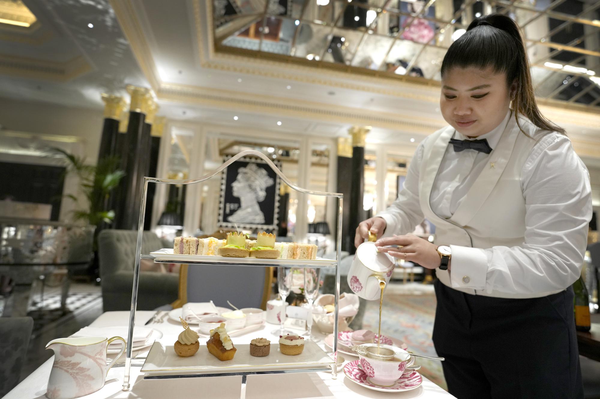 A Coronation themed tea is displayed at The Dorchester Hotel in London, Thursday, April 20, 2023. The Dorchester Hotel, long a favorite with royals and celebrities, concocted a lavish, five-tier coronation cake and put up theater-style draping across its facade to re-create the decorations that it used to mark Queen Elizabeth II’s coronation in 1953 in preparation for King Charles III's coronation on May 6. (AP Photo/Kirsty Wigglesworth)
