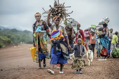 FILE - Residents flee fighting between M23 rebels and Congolese forces near Kibumba, some 20 kms ( 12 miles) North of Goma, Democratic republic of Congo, on Oct. 29, 2022. The accounts are haunting. Abductions, torture, rapes. Scores of civilians including women and children have been killed by the M23 rebels in eastern Congo, according to a U.N. report expected to be published this week. (AP Photo/Moses Sawasawa, File)