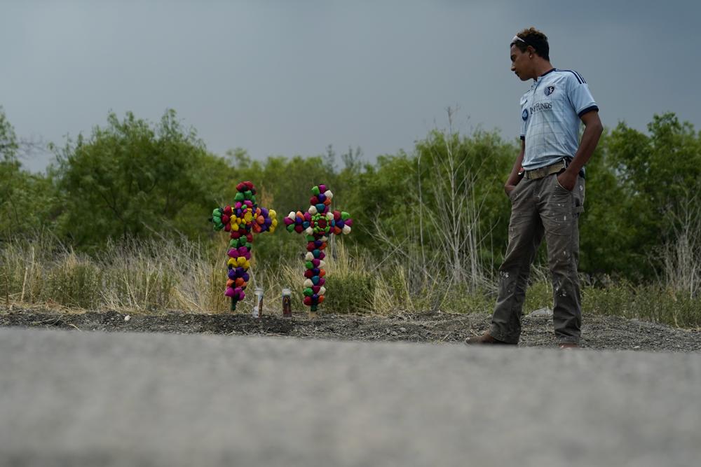 A man pays his respects at the site where officials found dozens of people dead in a semitrailer containing suspected migrants, Tuesday, June 28, 2022, in San Antonio. (AP Photo/Eric Gay)