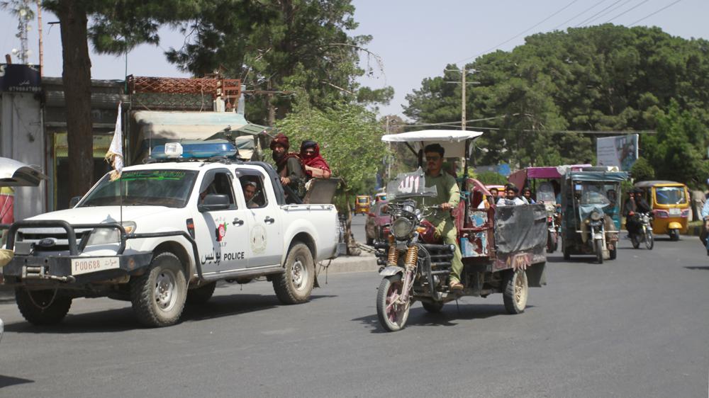 Members of the Taliban, left, drive with other motorists through city of Herat, Afghanistan, west of Kabul, Saturday, Aug. 14, 2021, after the province was taken from the Afghan government. (AP Photo/Hamed Sarfarazi)