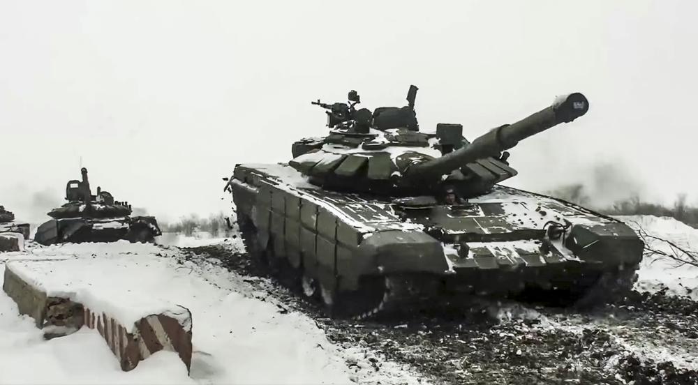 FILE - In this grab taken from video provided by the Russian Defense Ministry Press Service on Wednesday, Jan. 26, 2022, a Russian tanks roll during a military exercising at a training ground in Rostov region, Russia. The Kremlin, which has denied having any invasion plans, has scoffed at an argument that it wants to see the ground frozen to launch an attack on Ukraine. Ukrainian officials agree that the mud isn't an issue. (Russian Defense Ministry Press Service via AP, File)