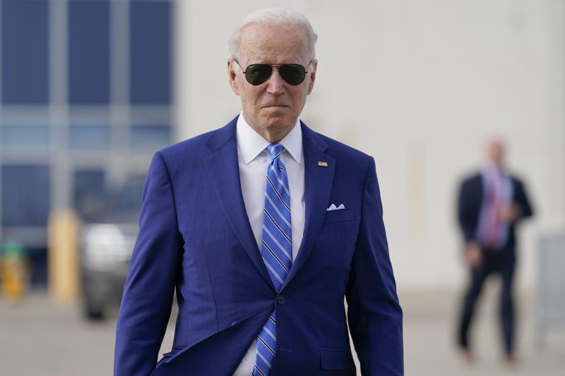 President Joe Biden walks to speak to reporters before boarding Air Force One at Des Moines International Airport, in Des Moines Iowa, Tuesday, April 12, 2022, en route to Washington. Biden said that Russia's war in Ukraine amounted to a "genocide," accusing President Vladimir Putin of trying to "wipe out the idea of even being a Ukrainian."(AP Photo/Carolyn Kaster)