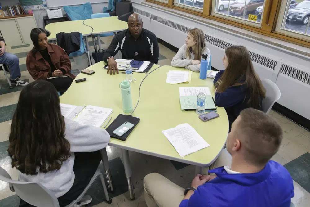 Troy Vincent, NFL Executive Vice President of Football Operations, top, speaks members of the "Flag Football United" initiative group at Mount St. Mary Academy on Wednesday, Jan. 18, 2023, in Kenmore, N.Y. (AP Photo/Joshua Bessex)