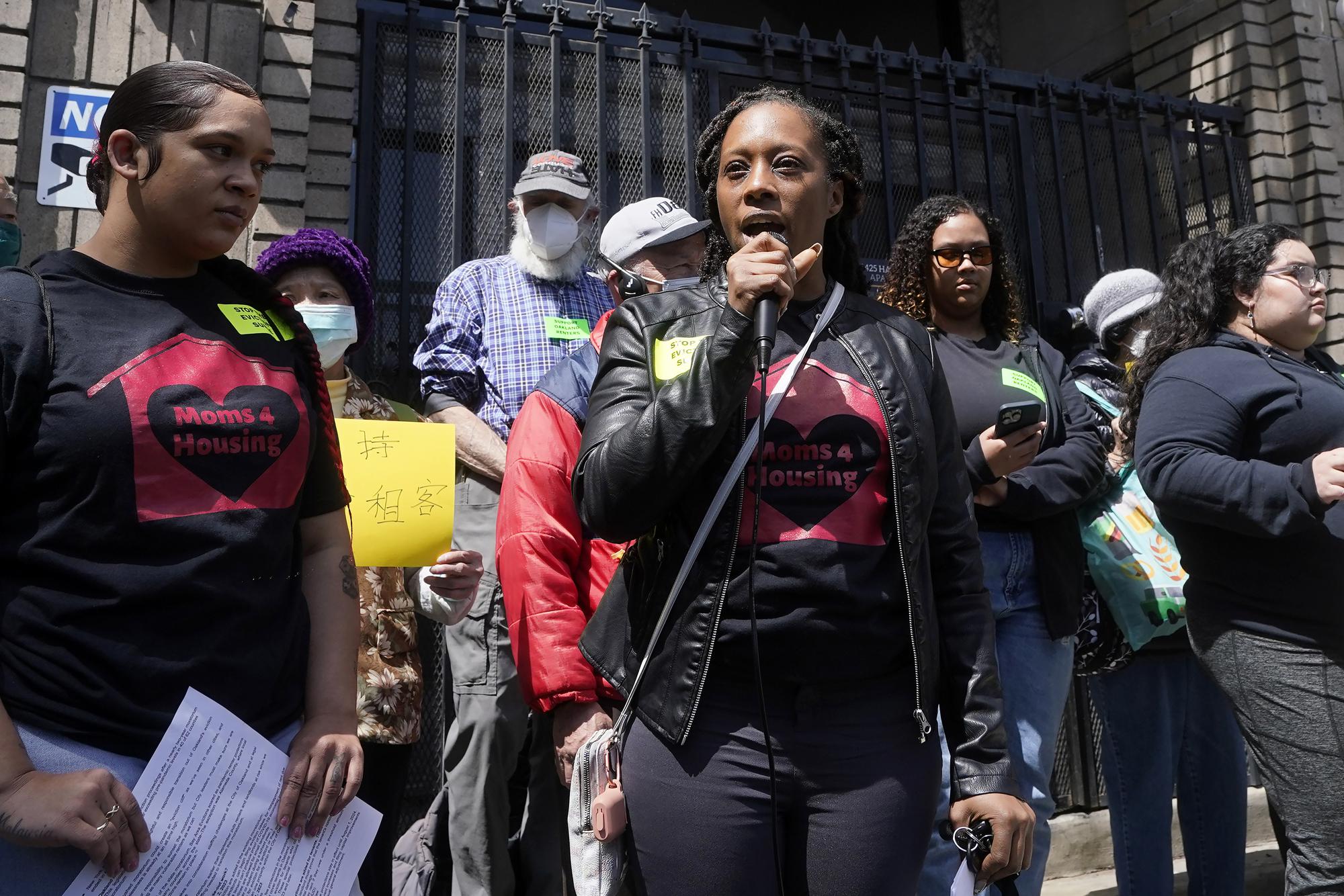 Dominique Walker, middle, of the group Moms 4 Housing, speaks during a rally in support of a ramp down of the eviction moratorium in Oakland, Calif., Tuesday, April 11, 2023. Eviction moratoriums were set in place across the U.S. at the start of the pandemic and most have expired, but not in the Bay Area cities of Oakland, San Francisco and Berkeley, where housing and rates of homelessness are both high. Housing advocates say low-income tenants still need protections. Oakland's eviction ban lifts July 15. (AP Photo/Jeff Chiu)