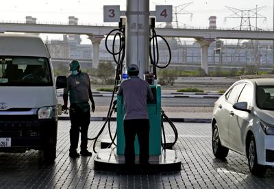 A gas station attendant fills a gas tank in Dubai, United Arab Emirates, Sunday, July 10, 2022. Mere years ago, fuel was cheaper than bottled water in the oil-rich United Arab Emirates. Now, long lines snake outside gas stations on the eve of monthly price hikes. (AP Photo/Kamran Jebreili)
