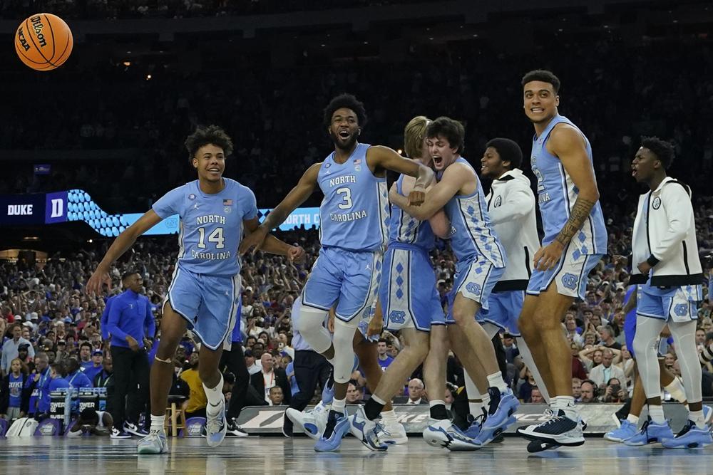 FILE - North Carolina players celebrate their victory against Duke after a college basketball game in the semifinal round of the Mens Final Four NCAA tournament Saturday April 2 2022 in New Orleans North Carolina won 81-77 With four starters back from the team that blew a 15-point halftime lead to Kansas at the Superdome in New Orleans the Tar Heels were the runaway pick as the preseason No 1 in the AP Top 25 on Monday Oct 17 2022 AP PhotoDavid J Phillip File