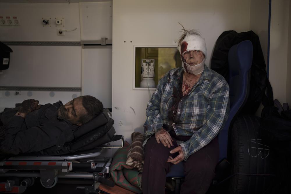 Injured civilians sit in an ambulance before being taken to a hospital after a Russian attack in Kharkiv, Ukraine, Saturday, April 16, 2022. (AP Photo/Felipe Dana)