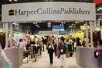 FILE - Attendees at BookExpo America visit the HarperCollins Publishers booth in New York on May 28, 2015. (AP Photo/Mark Lennihan, File)