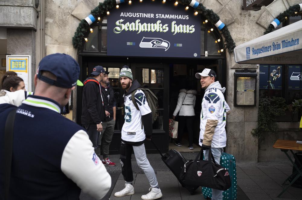 Fans of the Seahawks arrive at the Augustiner Original Building Beer Hall with Seattle Seahawks decor in Munich, Germany, Saturday, Nov. 12, 2022. The Tampa Bay Buccaneers will take on the Seattle Seahawks at Munich in the first ever regular season NFL football game in Germany this Sunday. (AP Photo/Markus Schreiber)