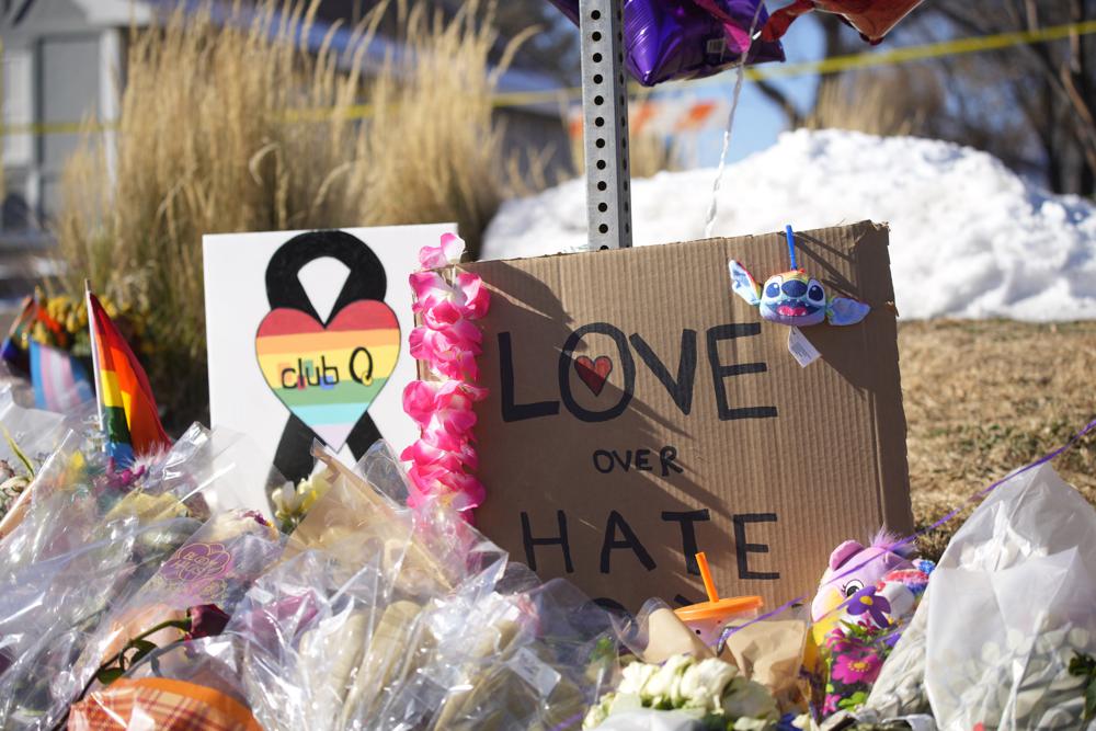 Bouquets of flowers sit on a corner near the site of a mass shooting at a gay bar Monday, Nov. 21, 2022, in Colorado Springs, Colo.  Club Q on its Facebook page thanked the "quick reactions of heroic customers that subdued the gunman and ended this hate attack.” (AP Photo/David Zalubowski)