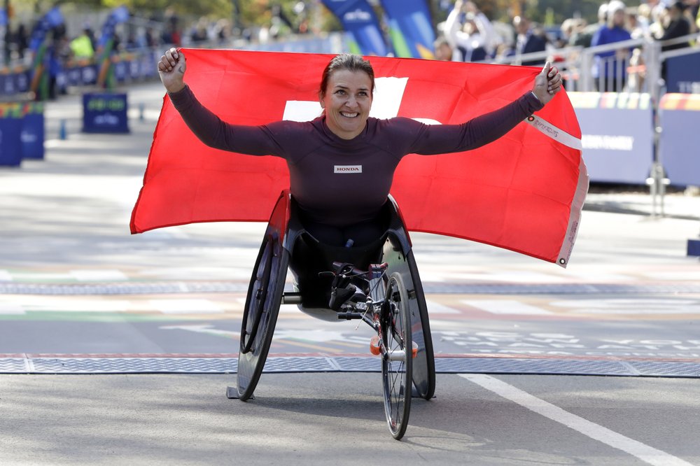 Manuela Schar, of Switzerland, poses for photos as the winner of the pro wheelchair women's division of the New York City Marathon, in New York's Central Park, Sunday, Nov. 3, 2019. (AP Photo/Richard Drew)