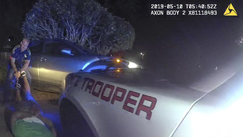 This image from video from Louisiana state police state trooper Dakota DeMoss' body-worn camera, shows trooper Kory York grabbing the leg shackles and dragging Ronald Greene on his stomach on May 10, 2019, outside of Monroe, La. The video obtained by The Associated Press shows Louisiana state troopers stunning, punching and dragging the Black man as he apologizes for leading them on a high-speed chase, footage authorities refused to release in the two years since Greene died in police custody. (Louisiana State Police via AP)