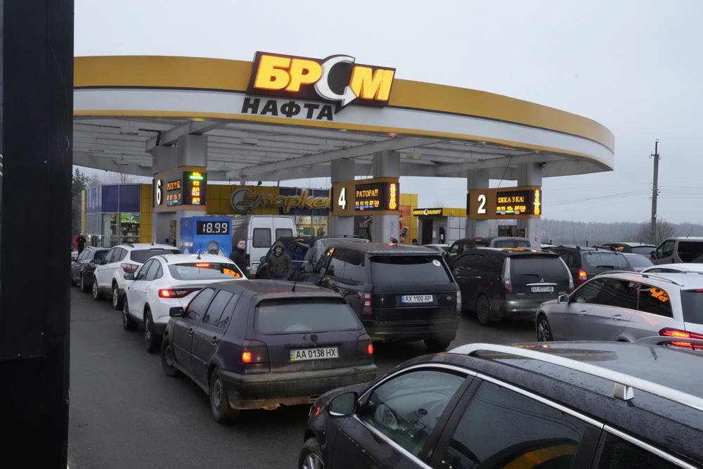 Vehicles line up to a gasoline station in Kyiv, Ukraine, Thursday, Feb. 24, 2022. Russian troops have launched their anticipated attack on Ukraine. Big explosions were heard before dawn in Kyiv, Kharkiv and Odesa, as world leaders decried the start of an Russian invasion that could cause massive casualties and topple Ukraine's democratically elected government. (AP Photo/Efrem Lukatsky)