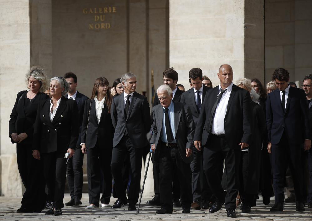 Paul Belmondo, center left, son of French actor Jean-Paul Belmondo, Alain Belmondo, center, the actor's brother, and relatives arrive at the Hotel des Invalides, Thursday, Sept.9 2021 in Paris. France is paying respects Thursday to screen legend Jean-Paul Belmondo with a solemn ceremony led by the president and a public viewing at Napoleon's final resting place. (Ian Langsdon, Pool Photo via AP)