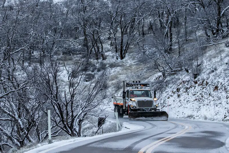 A snow plow works along Mt Hamilton road in Unincorporated Santa Clara County, Calif. Thursday, Feb. 23, 2023. (Stephen Lam/San Francisco Chronicle via AP)