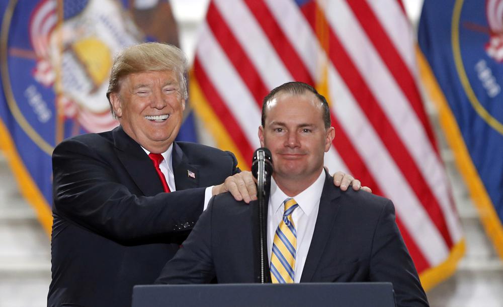 FILE - President Donald Trump stands with Sen. Mike Lee, R-Utah, on Dec. 4, 2017, at the Utah State Capitol, after Trump traveled to Salt Lake City to announce plans to shrink two sprawling national monuments in Utah. Lee has avoided serious challenge in deeply conservative Utah in the dozen years since he came to power in a Tea Party wave, but that's changing this year as he faces two GOP challengers and a newly empowered independent. (AP Photo/Rick Bowmer, File)