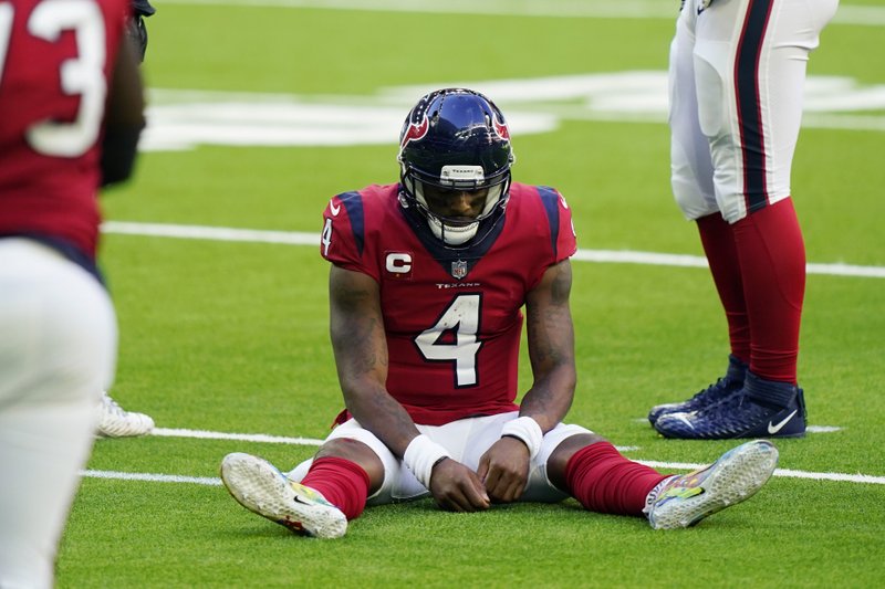 Deshaun Watson sits on the turf and is tired of losing