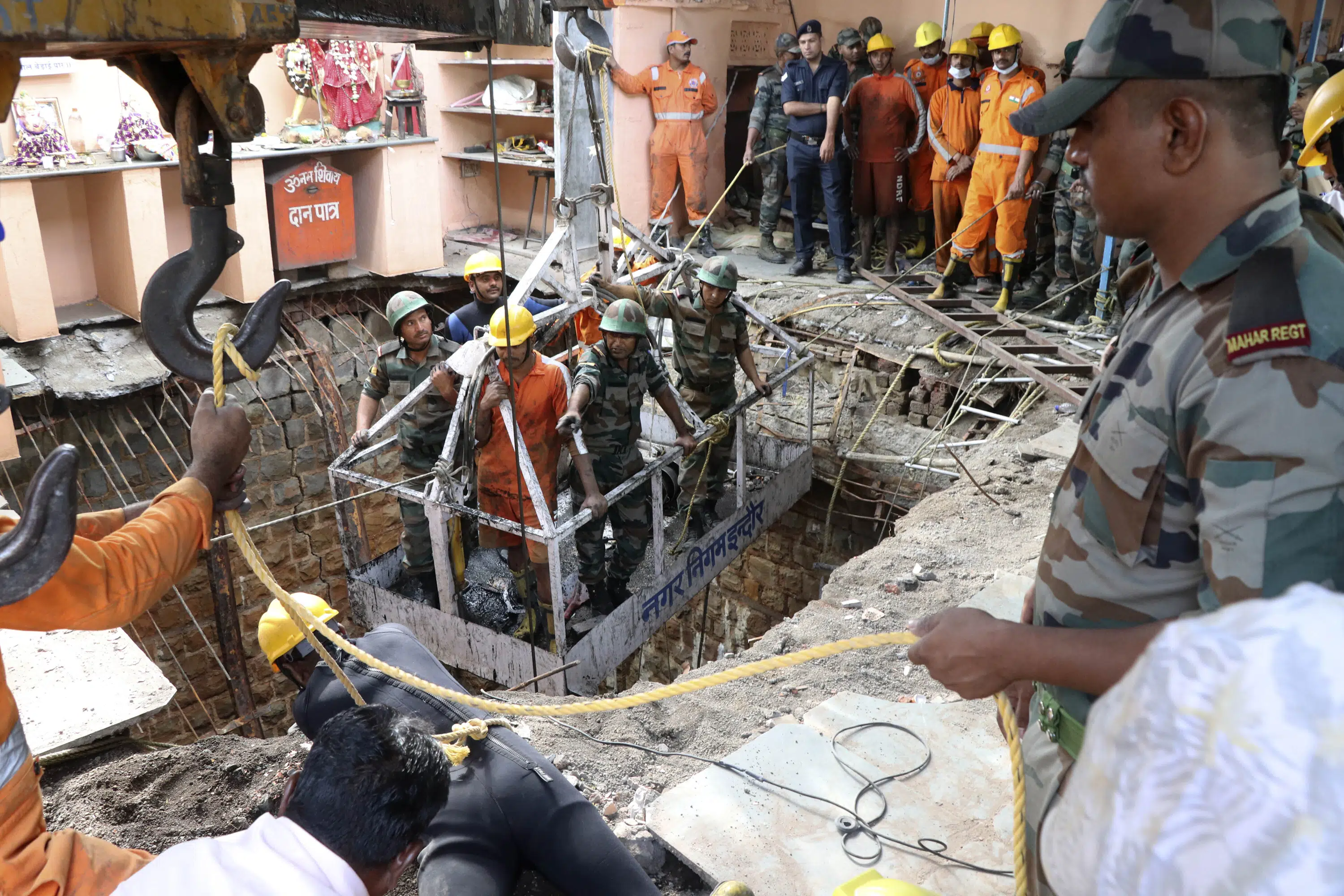 35 bodies found inside well after collapse at Indian temple - The Associated Press