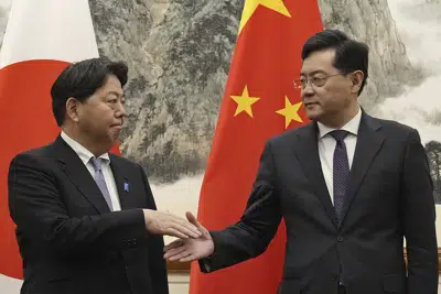 El ministro de exteriores de Japón Yoshimasa Hayashi (i) con su homólogo chino Qin Gang en Beijing el 2 de abril de 2023. (Kyodo News via AP)