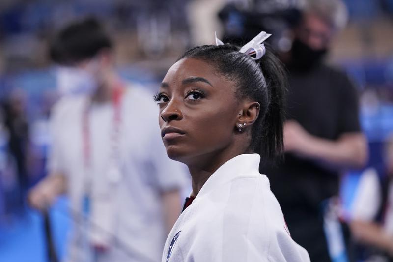 Simone Biles, of the United States, waits for her turn to perform during the artistic gymnastics women's final at the 2020 Summer Olympics, Tuesday, July 27, 2021, in Tokyo. (AP Photo/Gregory Bull)