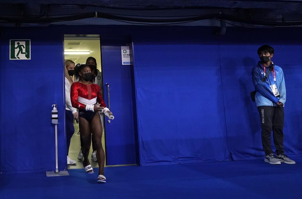 Simone Biles, of the United States, enters the court for the artistic gymnastics women's final at the 2020 Summer Olympics, Tuesday, July 27, 2021, in Tokyo. (AP Photo/Gregory Bull)