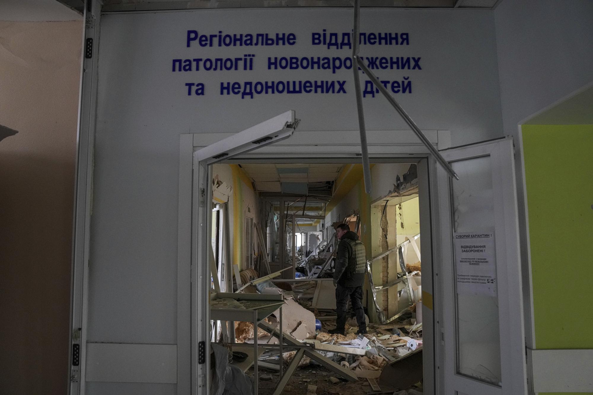 FILE - A volunteer works inside a maternity hospital damaged by shelling in Mariupol, Ukraine, March 9, 2022. (AP Photo/Evgeniy Maloletka, File)