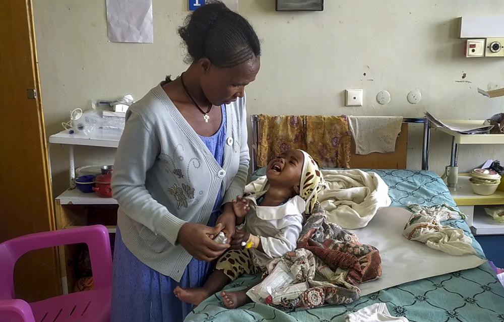 In this image made from video provided anonymously, an unidentified mother and child are seen in the malnutrition ward at the Ayder Referral Hospital in Mekele, in the Tigray region of northern Ethiopia, Tuesday, Sept. 28, 2021. In the regional capital Mekele, a year of war and months of government-enforced deprivation have left the city of a half-million people with a rapidly shrinking stock of food, fuel, medicine and cash. (AP Photo)