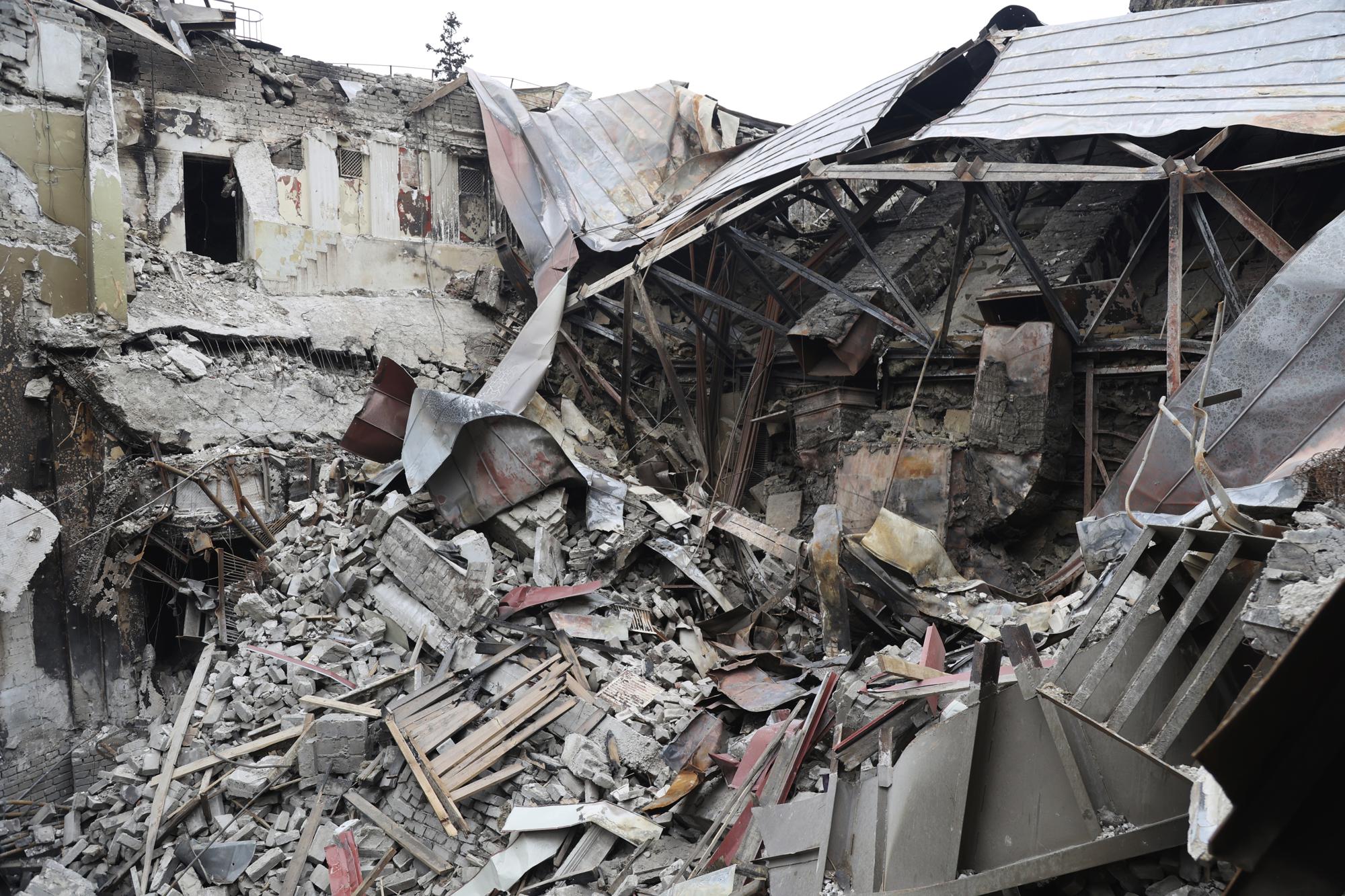 FILE - Rubble from the damaged Donetsk Academic Regional Drama Theatre sits after the March 16, 2022, bombing in Mariupol, Ukraine, in an area now controlled by Russian-backed separatist forces, on Monday, April 4, 2022. The bombing of the theater, which was used as a shelter, stands out as the single deadliest known attack against civilians to date in the Ukraine war. (AP Photo/Alexei Alexandrov, File)