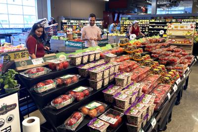 People shop at a grocery store in Glenview, Ill., Monday, July 4, 2022. The problems have hardly gone away. Inflation, still near a 40-year high, is punishing households. Rising interest rates have derailed the housing market and threaten to inflict broader damage. And the outlook for the world economy grows bleaker the longer the war in Ukraine drags on. (AP Photo/Nam Y. Huh)